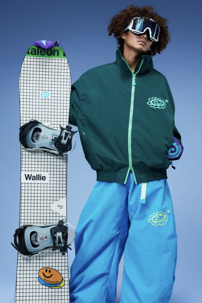 OddyEddy Ash Green ski jacket styled with blue snowboard pants and snowboard