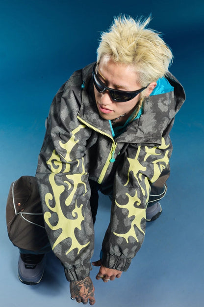 OddyEddy Thorn Grey snowboard jacket action pose showing sleeve graphics