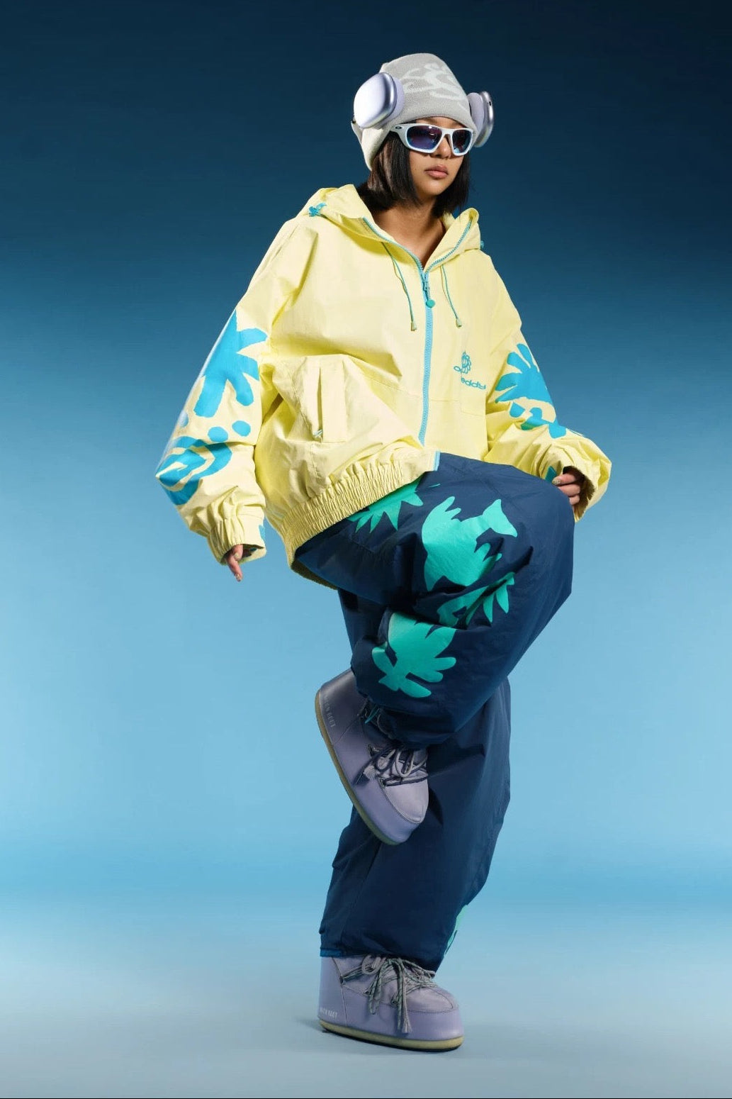OddyEddy Totem Yellow jacket action styling with blue snowboard pants