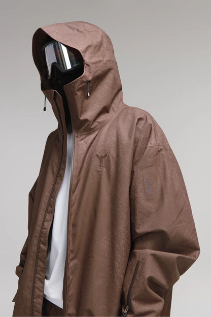 Close-up of Winter Ticket dark brown leather-look jacket fabric, hood, chest logo and sleeve