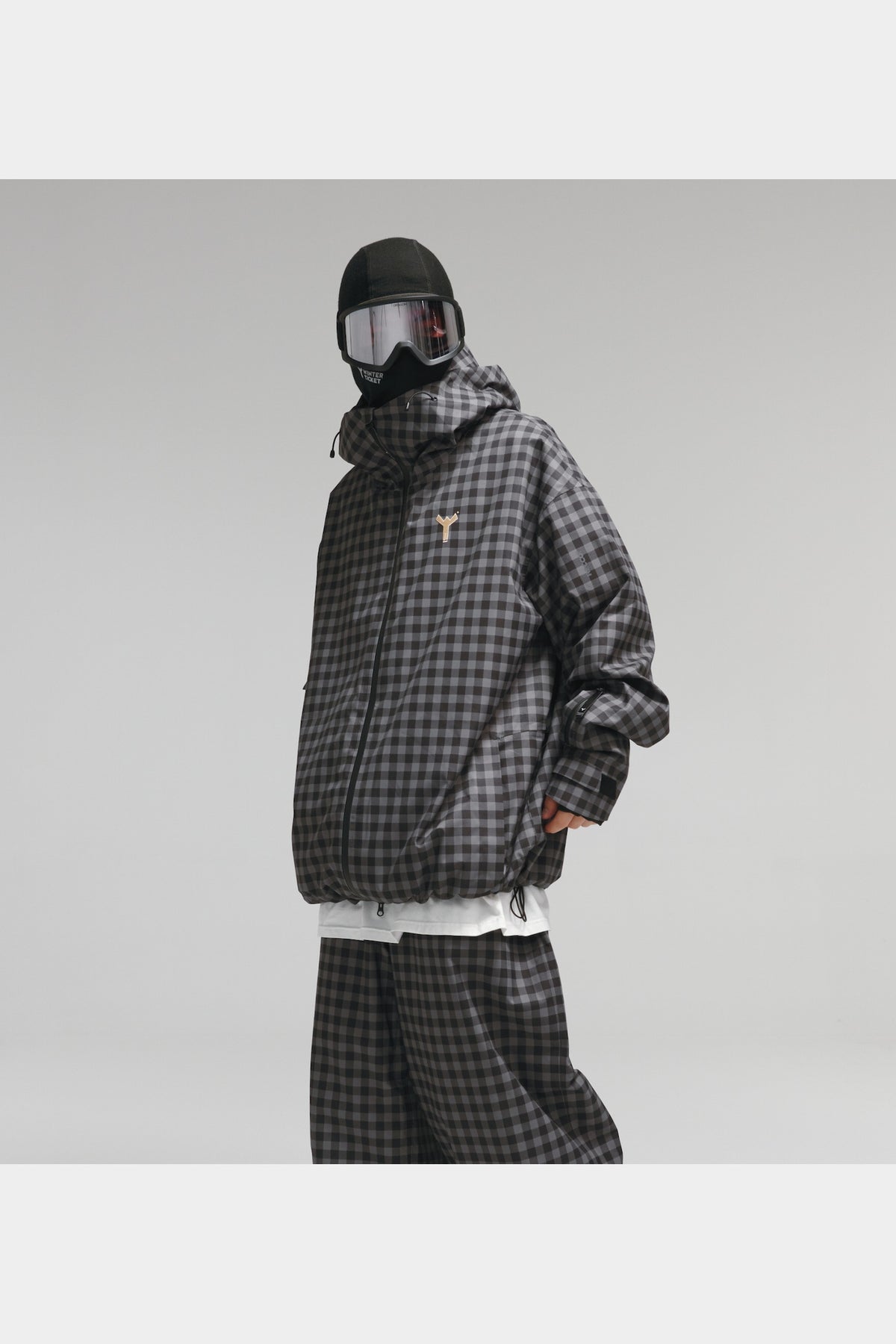 Black-grey plaid jacket angled view showing oversized fit and sleeve pocket