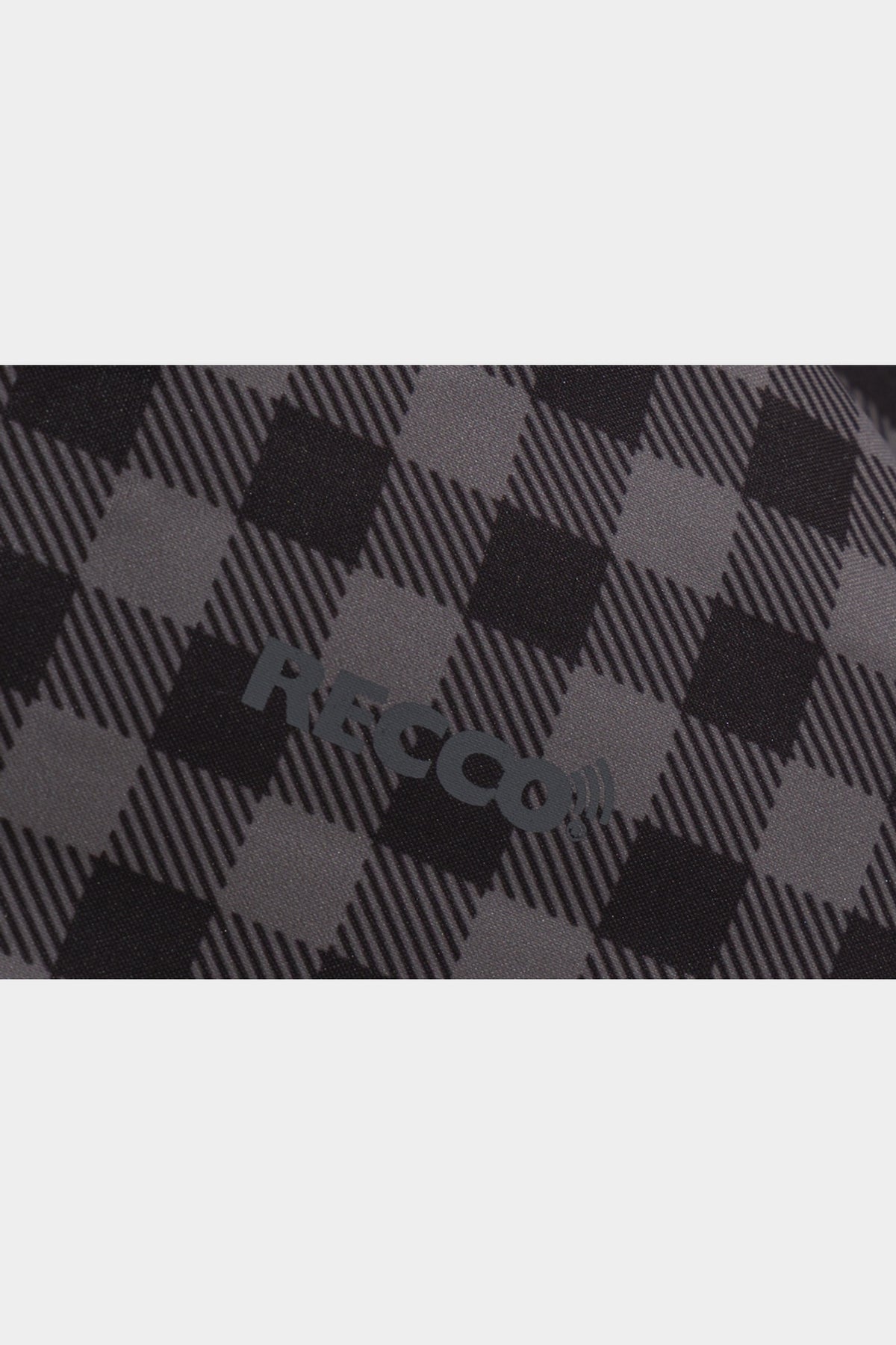 Black-grey plaid jacket fabric detail with RECCO marking