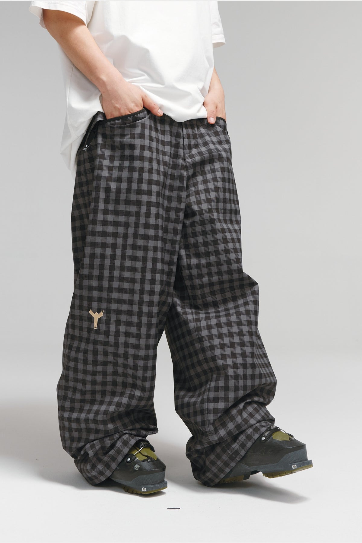 Winter Ticket black-grey plaid snow pants, front angled view showing wide-leg freestyle fit